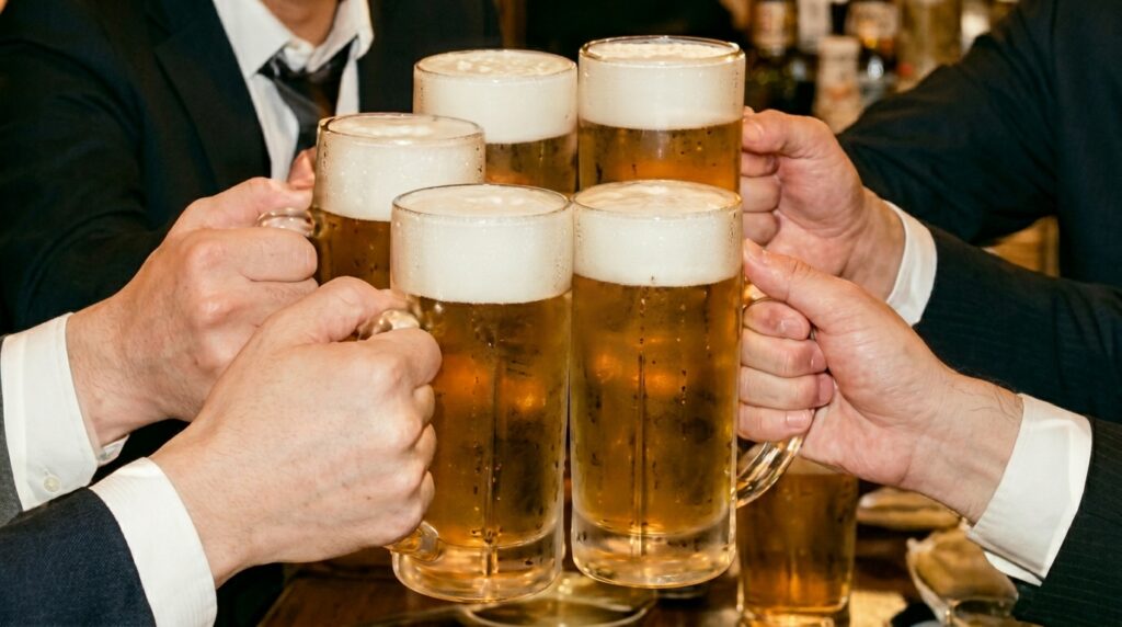 A group of Japanese salarymen at an izakaya table. Jackets on, ties loosened. All holding identical mugs of draft beer, mid-kanpai. Their faces are turned toward each other. The beers are the same.